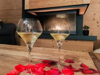 two glasses of white wine sitting on a table at Luxury Wood Megeve village in Megève