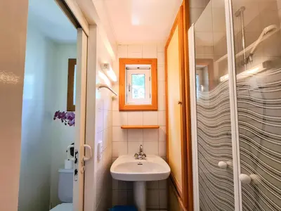 a small bathroom with a sink and a shower at Résidence Hameau - Chalet confortable · Poêle à bois · Terrasse · Garage · WIFI gratuit MAE-8714 in Magland