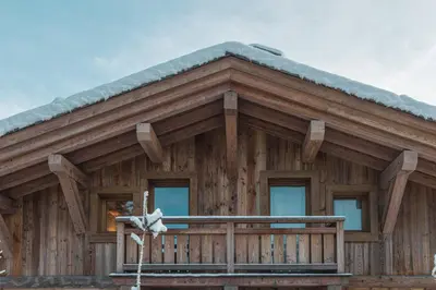 a log cabin with a snow covered roof at Pas de l’Ourson - Megève - Chalet with Sauna in Megève