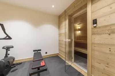 a gym with a treadmill and a sauna at Pas de l’Ourson - Megève - Chalet with Sauna in Megève