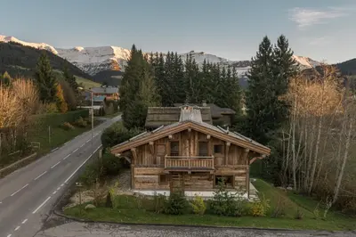 a wooden house on the side of a road at Pas de l’Ourson - Megève - Chalet with Sauna in Megève