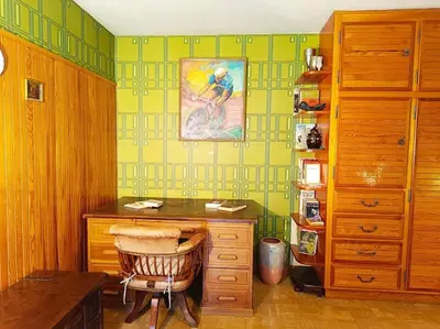 a room with a desk and a painting on the wall at La Maison des Praz in Saint-Gervais-les-Bains