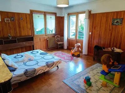 a bedroom with a bed and two dolls in it at La Maison des Praz in Saint-Gervais-les-Bains