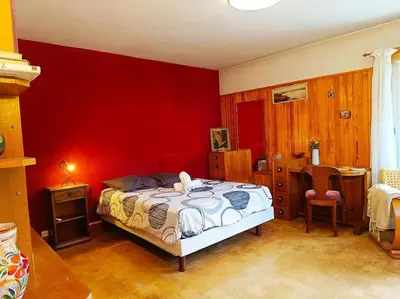 a bedroom with a bed and a red wall at La Maison des Praz in Saint-Gervais-les-Bains
