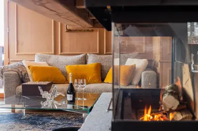 a living room with a couch and a fireplace at Chalet Albert 1 er Megeve village in Megève