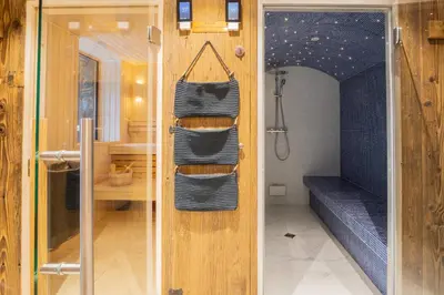 a bathroom with a shower and a towel rack at Chalet Albert 1 er Megeve village in Megève