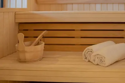 a sauna with towels and wooden utensils at Chalet Albert 1 er Megeve village in Megève