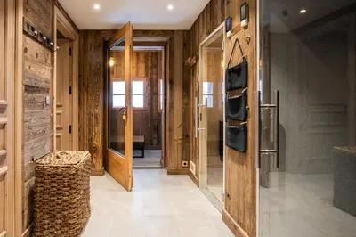 a hallway with wood paneled walls and a door at Chalet Albert 1 er Megeve village in Megève