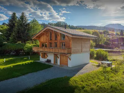 a small wooden house in a field with a yard at Chalet Alpayak - OVO Network in Combloux