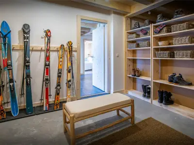a room with a bunch of skis on the wall at Chalet Alpayak - OVO Network in Combloux