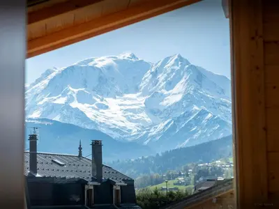a view of a snow covered mountain from a window at Chalet Alpayak - OVO Network in Combloux
