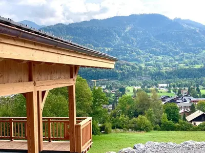 a porch of a house with a view of a mountain at Chalet****Luxe Sauna & SPA Le Champenois in Samoëns