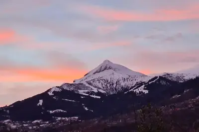 a snow covered mountain with a sunset in the background at Logement entier dans maison - Passy - 6 personnes in Passy