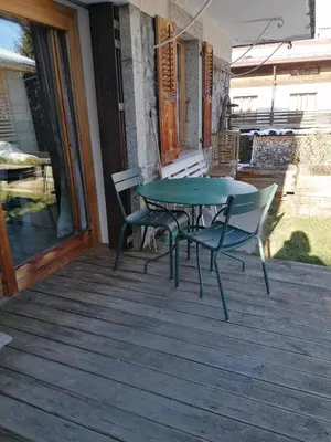 a table and two chairs on a porch at chalet Mont-Blanc in Combloux