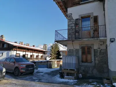 a car parked in a parking lot next to a building at chalet Mont-Blanc in Combloux