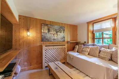 a living room with a couch and a window at Chalet White Moon in Demi-Quartier