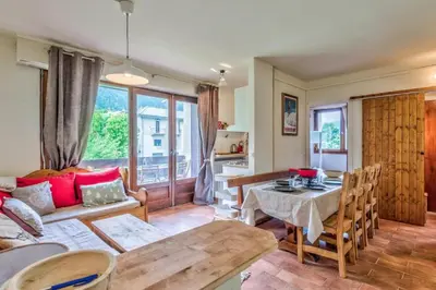 a living room with a couch and a table at Appartement Cosy, Chamonix Centre in Chamonix-Mont-Blanc