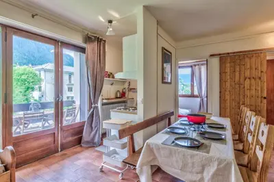 a kitchen with a table and a large window at Appartement Cosy, Chamonix Centre in Chamonix-Mont-Blanc