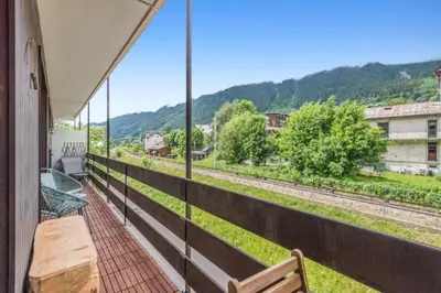 a balcony with a view of the train tracks at Appartement Cosy, Chamonix Centre in Chamonix-Mont-Blanc