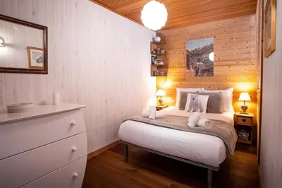 a bedroom with a bed with two towels on it at Refuge des Alpages - Duplex - Vue Aiguillette des Houches in Les Houches