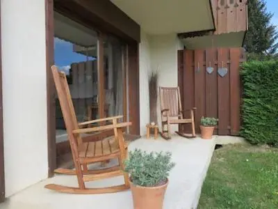 two chairs sitting on the porch of a house at Vue splendide Mont Blanc in Saint-Gervais-les-Bains