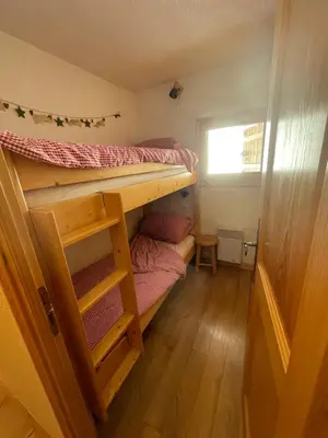 a room with two bunk beds and a window at Vue splendide Mont Blanc in Saint-Gervais-les-Bains