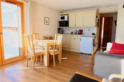 a kitchen and dining room with a table and chairs at Vue splendide Mont Blanc in Saint-Gervais-les-Bains