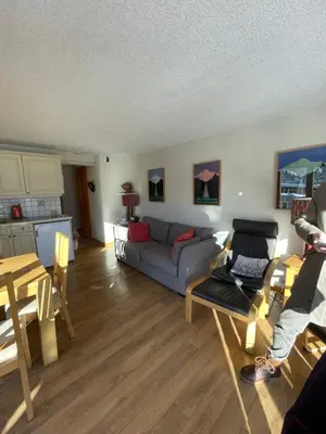 a living room with a couch and a table at Vue splendide Mont Blanc in Saint-Gervais-les-Bains