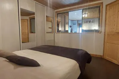 a bedroom with a large bed with a window at Les Hauts de Sallanches in Sallanches