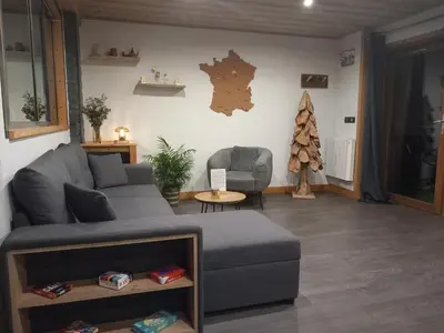 a living room with a couch and a chair at Les Hauts de Sallanches in Sallanches