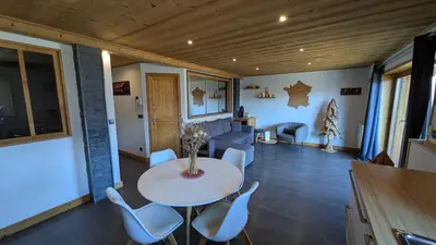 a living room with a table and chairs at Les Hauts de Sallanches in Sallanches
