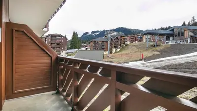 a balcony with a view of a city with buildings at Les Eterlous- 19- Appart pied des pistes- 6 pers in Morillon