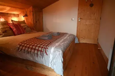 a large white bed with two pillows on it at Three bedroom Apartment, Samoens, Grand Massif in Samoëns