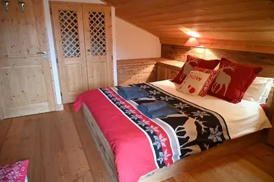 a living room with a couch and a wooden staircase at Three bedroom Apartment, Samoens, Grand Massif in Samoëns