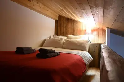 a bedroom with a bed in a wooden cabin at Three bedroom Apartment, Samoens, Grand Massif in Samoëns