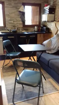a living room with two chairs and a table and a couch at SebRem in Megève