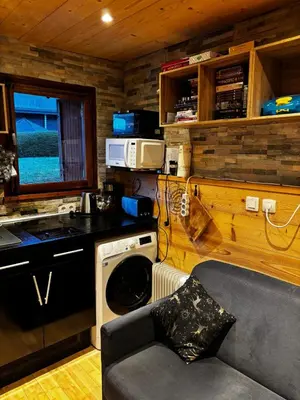 a kitchen with a stove and a washing machine at SebRem in Megève