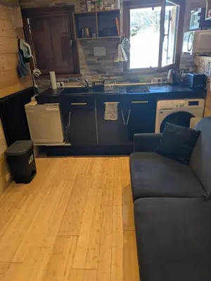 a living room with a couch and a kitchen at SebRem in Megève