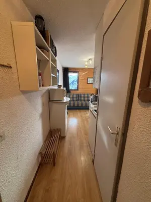 a small room with a refrigerator and a kitchen at Samoens 1600 les cimes in Samoëns