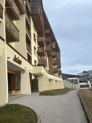 an apartment building with a driveway in front of it at Samoens 1600 les cimes in Samoëns