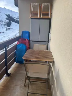 a table and chairs on the balcony of a room at Samoens 1600 les cimes in Samoëns