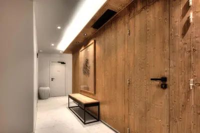 a hallway with a wooden wall with a bench on it at Stallion d15 MEGEVE in Megève