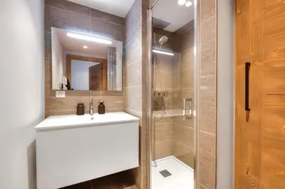 a bathroom with a sink and a shower at Stallion d15 MEGEVE in Megève