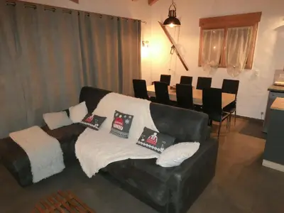 a living room with a couch and a table with chairs at SUPERBE DEMI CHALET LUXUEUX 120M² 8 Personnes à SALLANCHES. in Sallanches