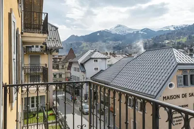a view from a balcony of a town with mountains at Conseil B - Chic 2BR City Center Apartment - Free Parking & Mountain View - By Cozee Rentals in Saint-Gervais-les-Bains