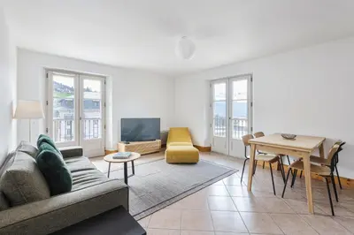 a living room with a couch and a table at Conseil B - Chic 2BR City Center Apartment - Free Parking & Mountain View - By Cozee Rentals in Saint-Gervais-les-Bains
