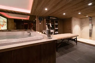 a large bathroom with a tub and a shower at Chalet des Ours I Le Chalet Club in Megève