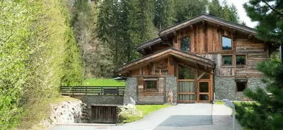 a log cabin with a pathway in front of it at Chalet des Ours I Le Chalet Club in Megève