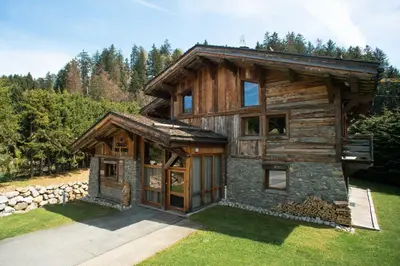 a log cabin in the middle of a yard at Chalet des Ours I Le Chalet Club in Megève