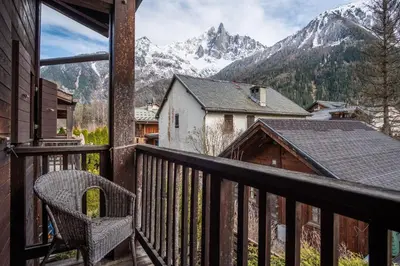 a balcony with a chair and a view of a mountain at Chalet Vorgeats 2 - 6 pers - Au pied de la Flégère - Golf - UTMB in Chamonix-Mont-Blanc